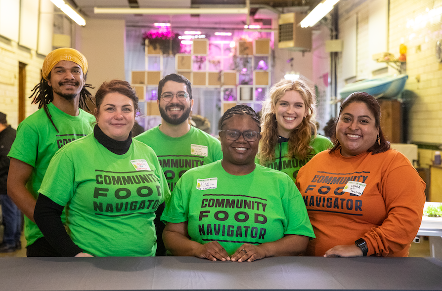 Six Community Food Navigator team members smile and pose for a group photo at the Navigator’s 2023 “Springtime Gathering”