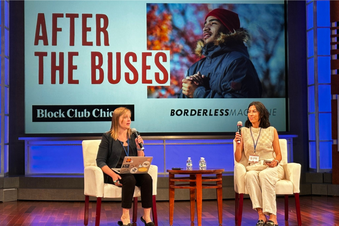 Two people sit in armchairs on a stage in front of a large screen with text "After the Buses"